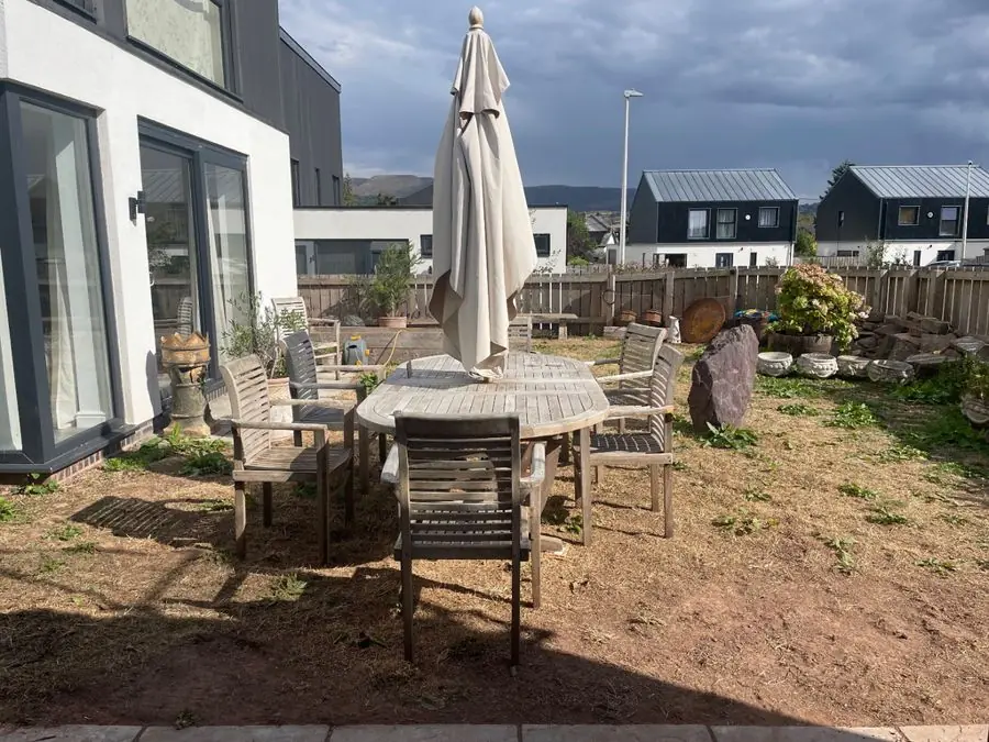 Paved terrace with a round raised bed: the garden before