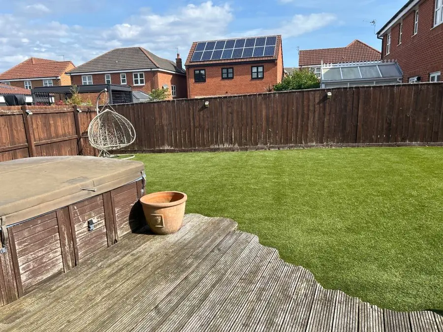 Patio with outdoor sofa and hot borders: the garden before