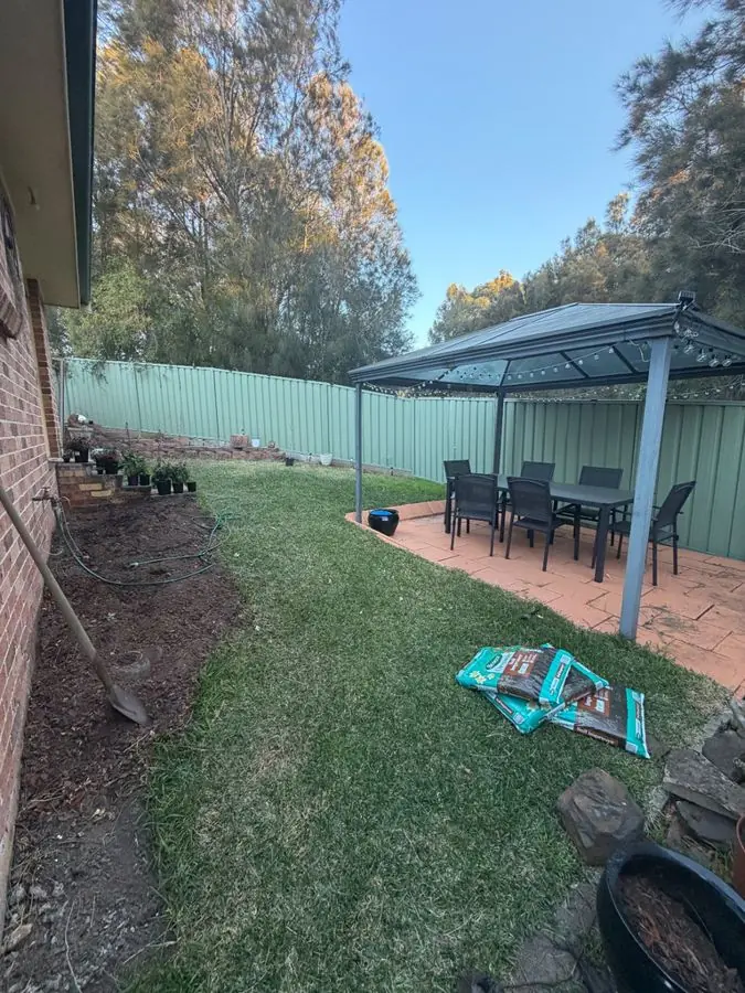 Lawn with stepping stones and a bistro table: the garden before