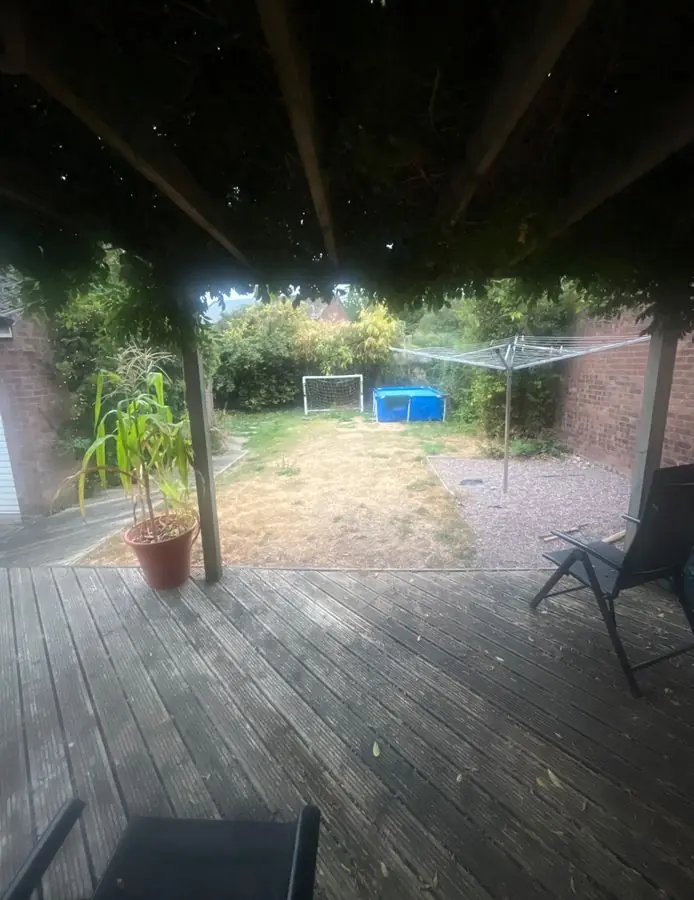 Wisteria pergola over a lawn: the garden before