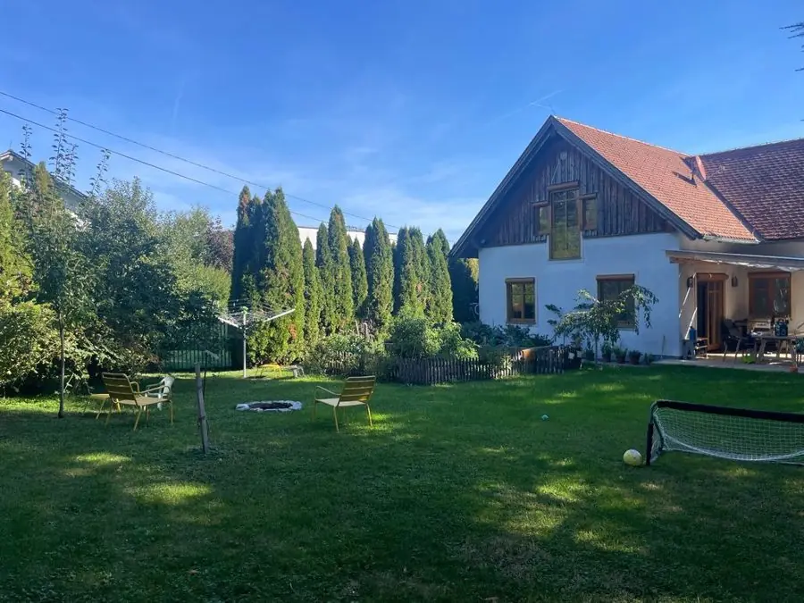 A big lawn with a football goal, fire pit and chairs, before the redesign