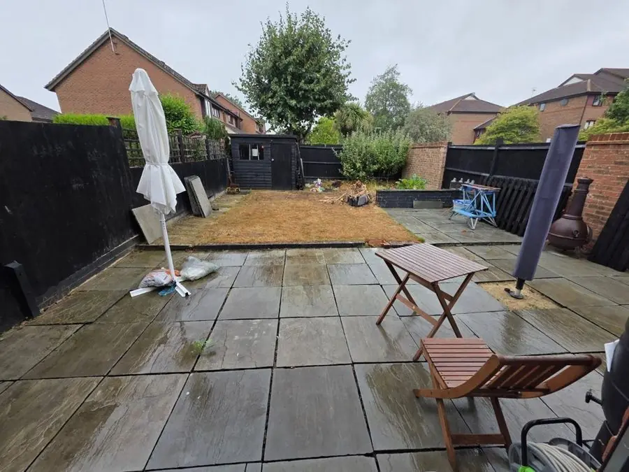 Paved garden with a rill and a tree: the garden before