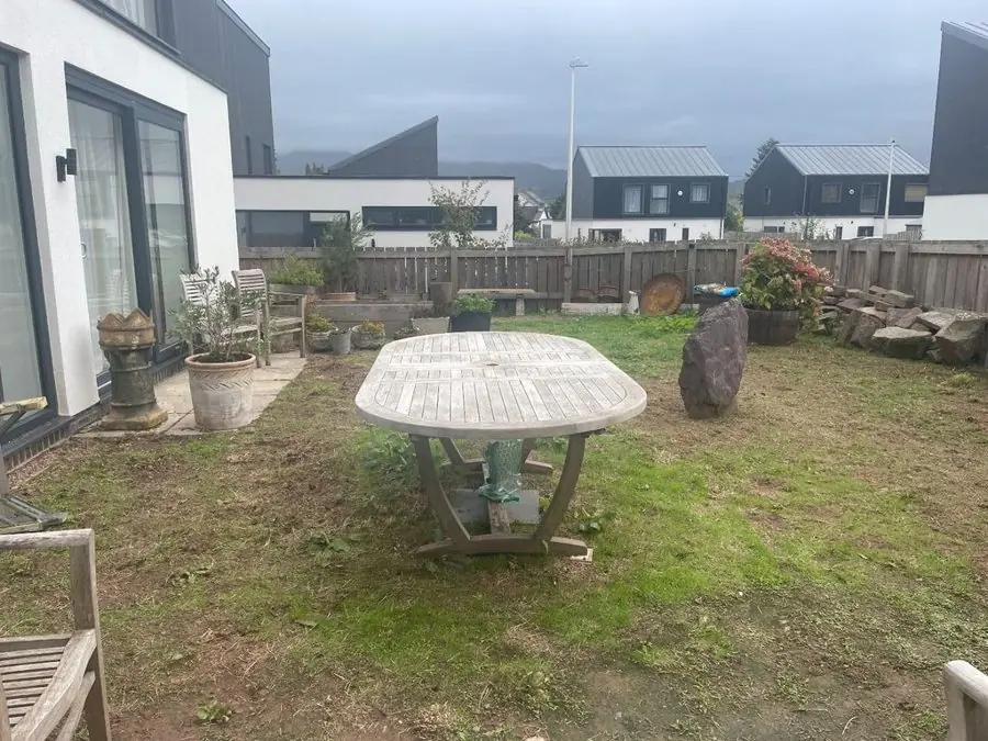 Black decking, a pond and a pergola: the garden before