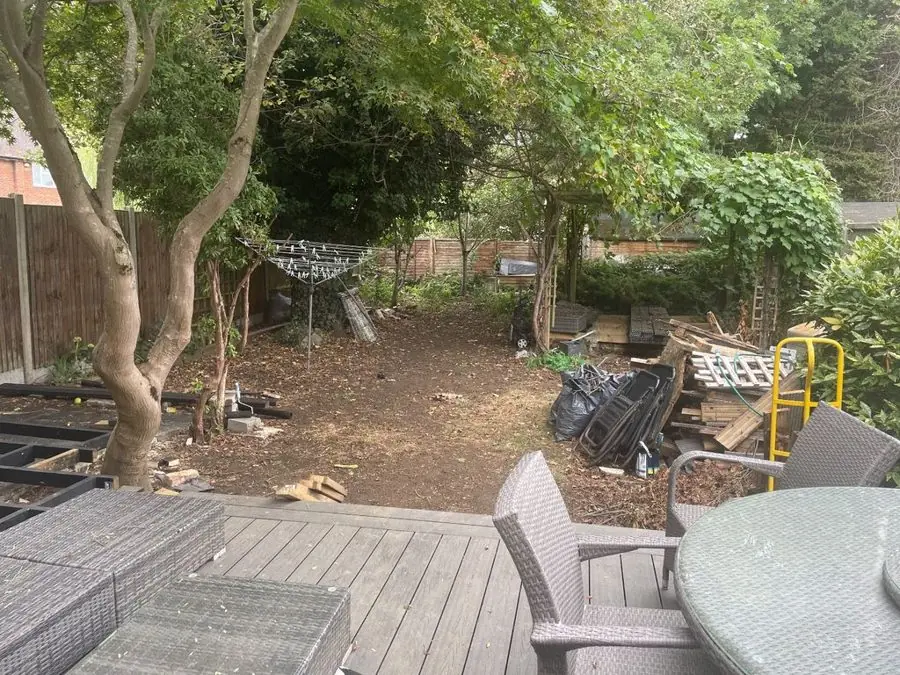 Shady garden with a water feature under trees: the garden before