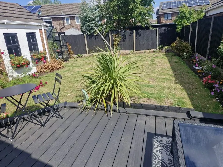 Patio, lawn and bold leaves: the garden before