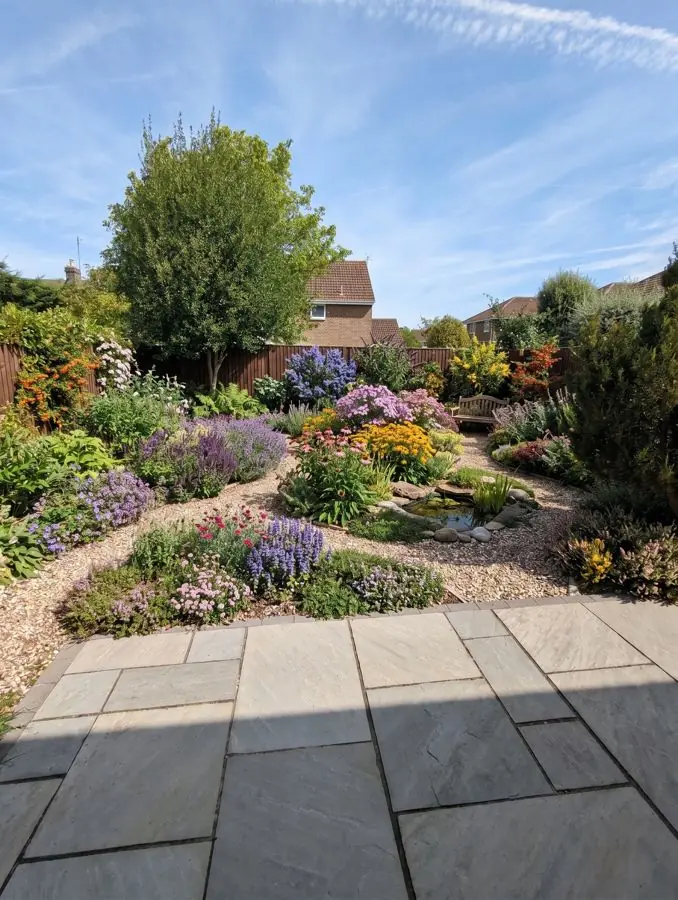 Gravel garden full of flowers, from the patio, a lawn garden idea