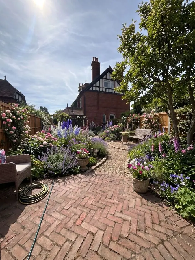 Herringbone brick path and cottage borders, a patio garden idea