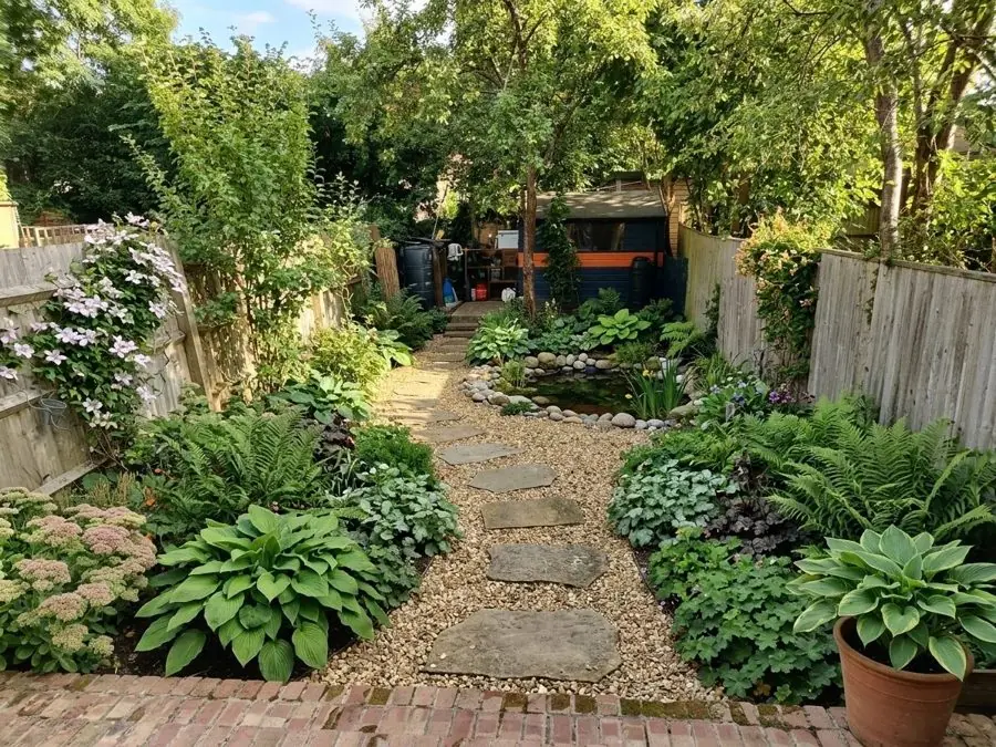 Hostas and ferns along a stepping stone path, redesigned