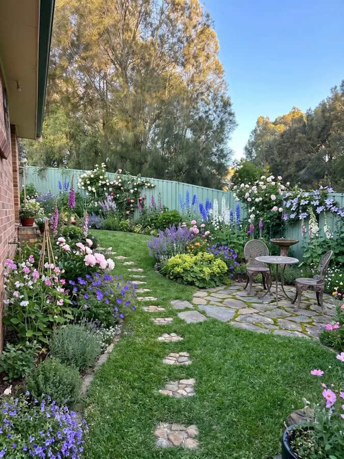 Lawn with stepping stones and a bistro table, redesigned