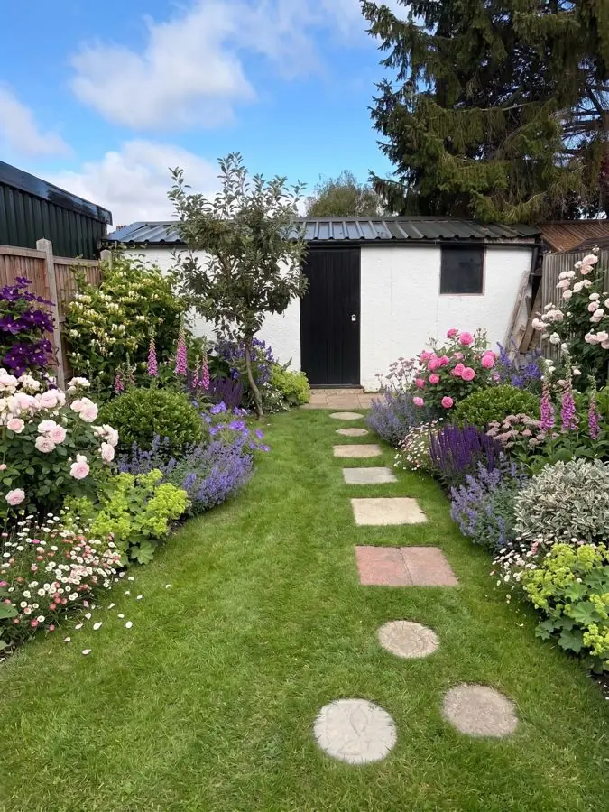 Lawn with stepping stones and full borders, redesigned