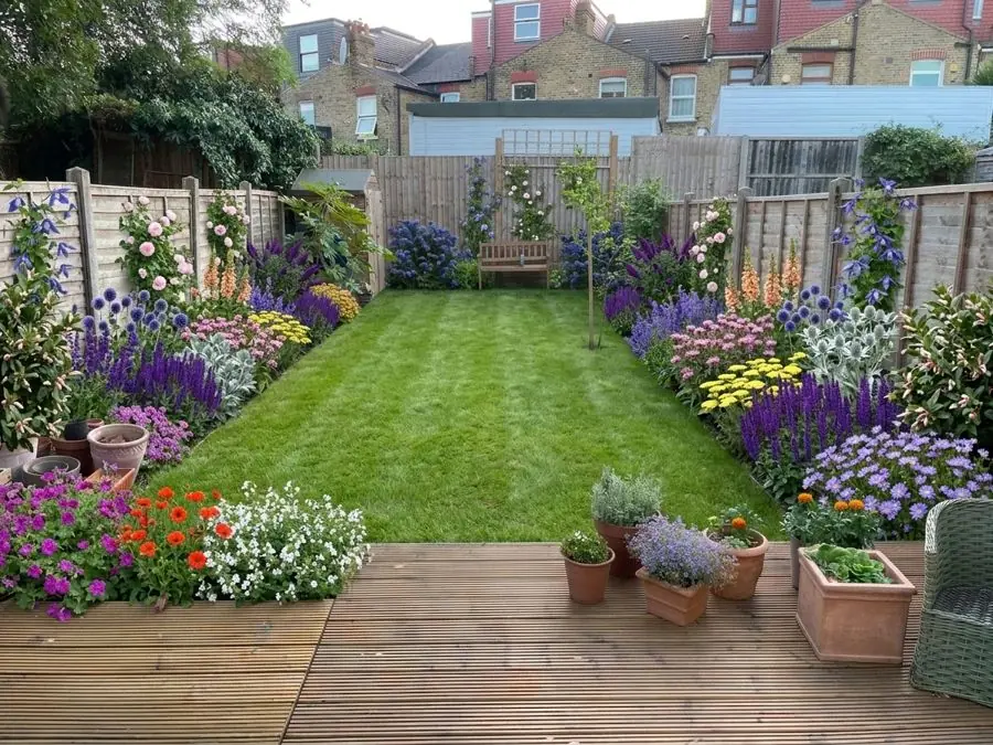 Long lawn framed by borders, from the deck, redesigned