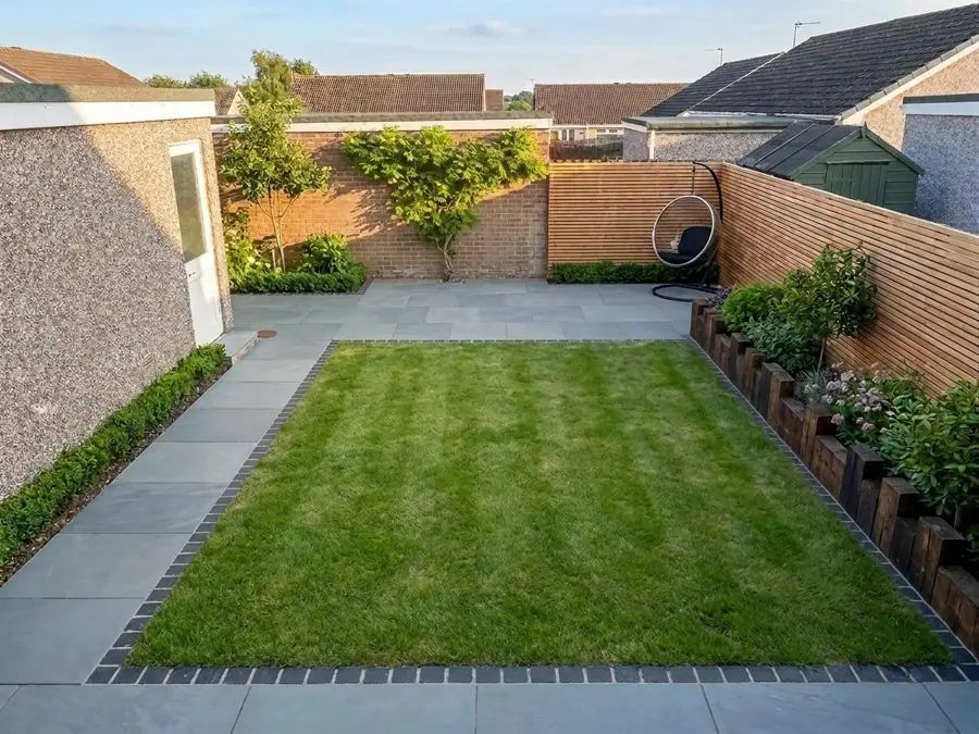 Neat lawn framed by grey paving, redesigned