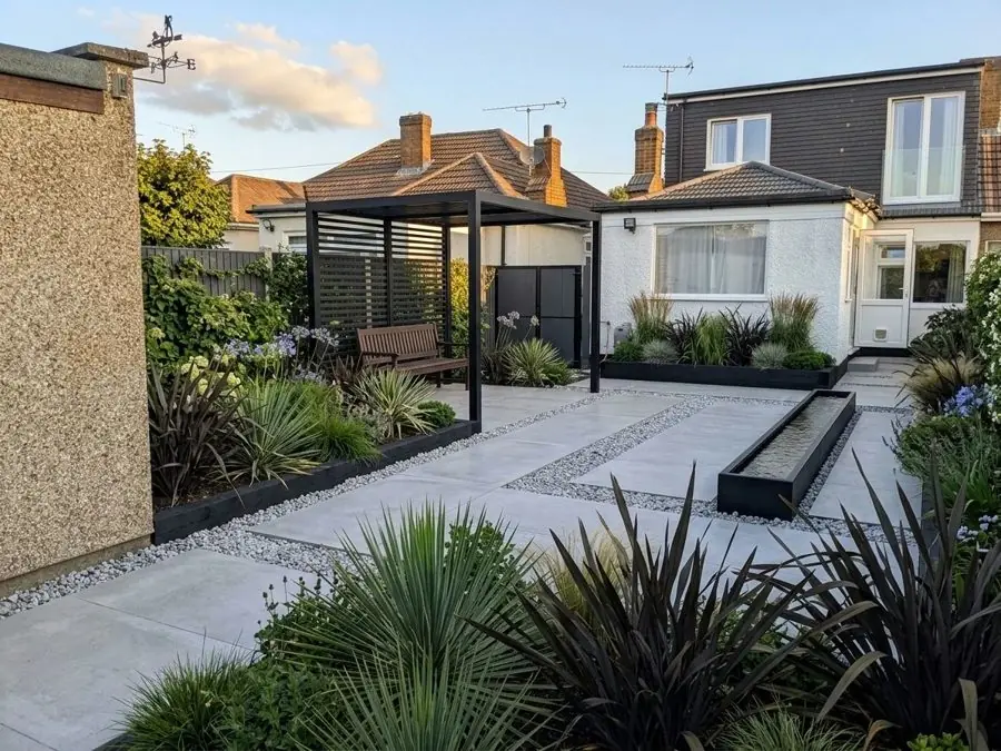 Pale paving, a pergola and spiky leaves, redesigned