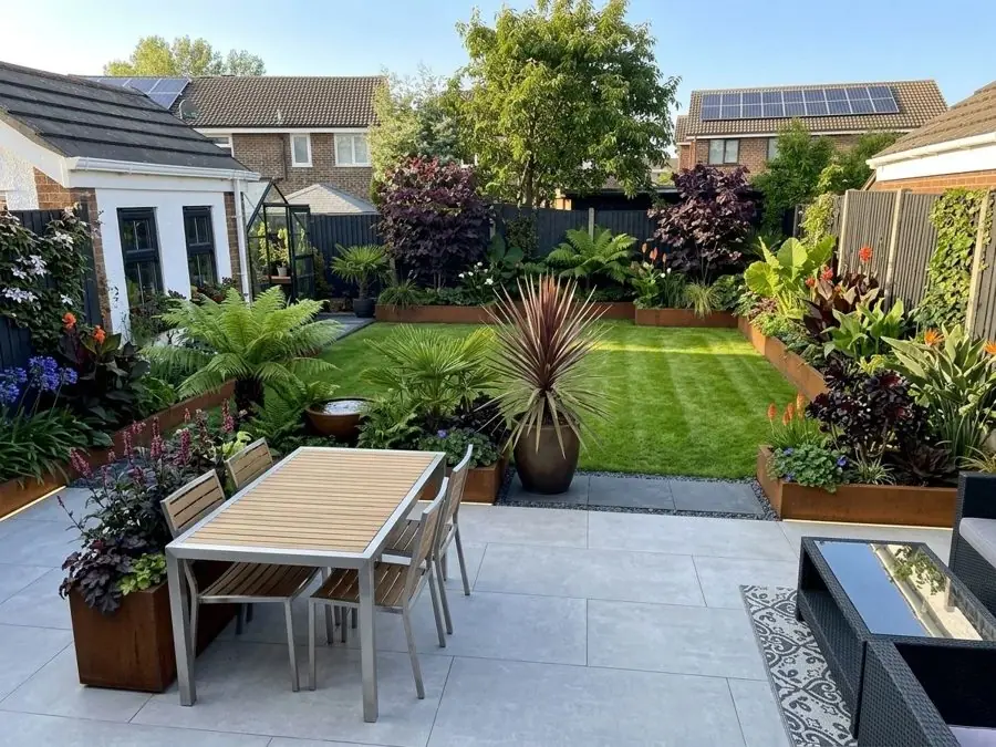 Patio, lawn and bold leaves, redesigned
