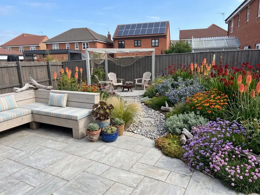 Patio with outdoor sofa and hot borders, redesigned