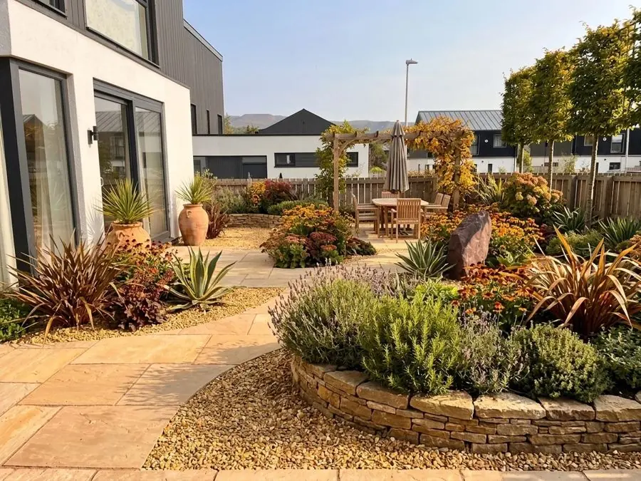 Paved terrace with a round raised bed, redesigned
