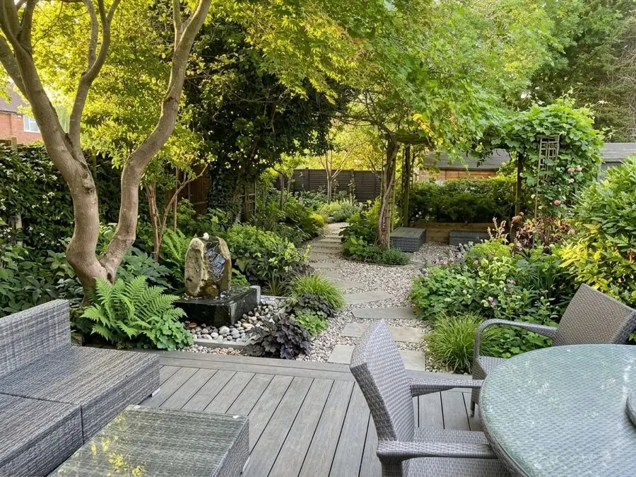 Shady garden with a water feature under trees, redesigned