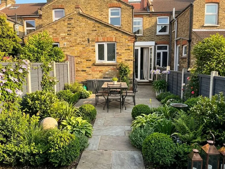 Terrace patio with clipped evergreens, redesigned