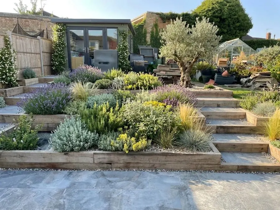 Terraced sleeper beds of silver plants, redesigned