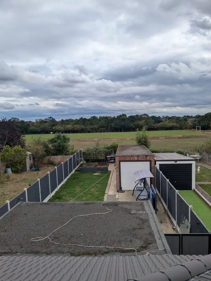 Seen from upstairs: bare soil, a lawn strip and a garage, before the redesign