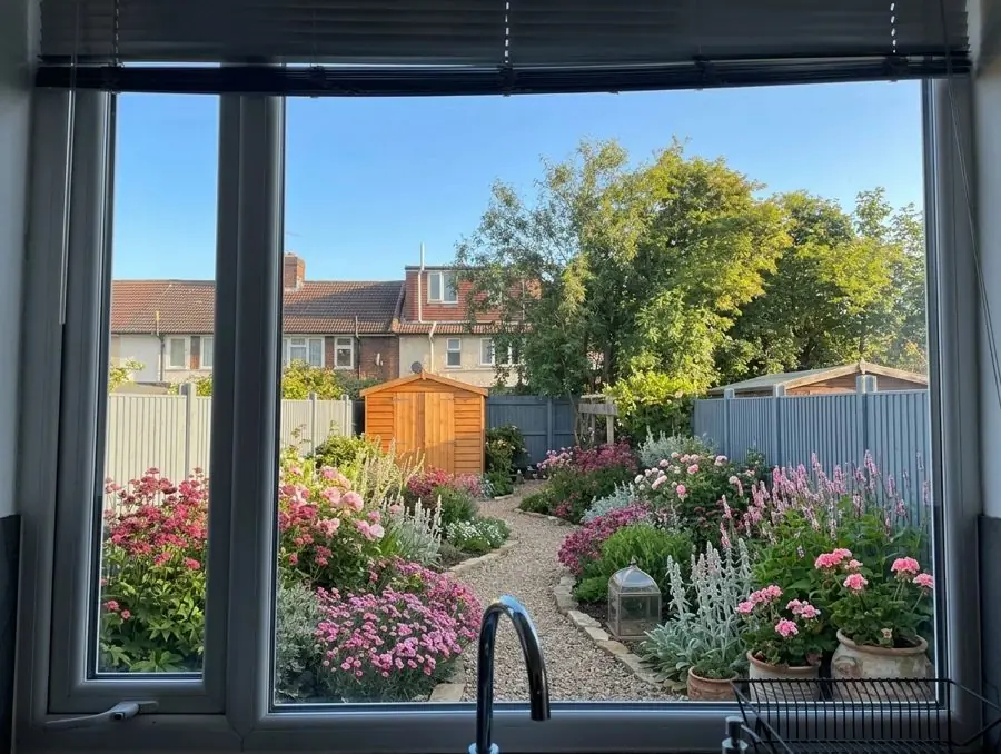 A gravel path through pink planting, an idea for an overgrown garden