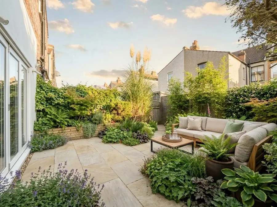 Lawn swapped for a sandstone patio and a sofa, designed with the app