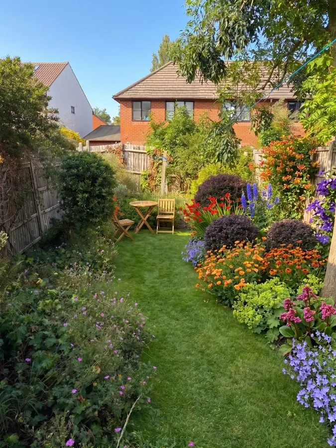 A mown lawn with deep flower borders, an idea for an overgrown garden