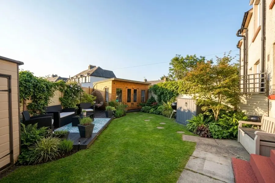 A narrow lawn with borders of ferns and grasses along both sides, designed with the app