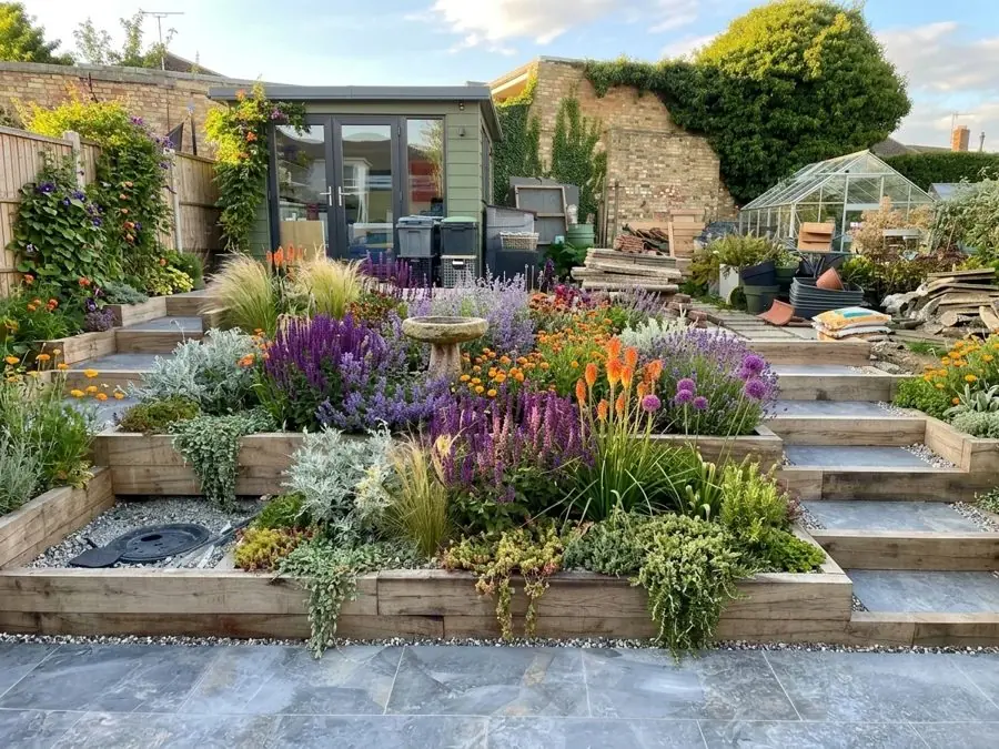 Raised sleeper beds and steps planted with lavender, red hot pokers and silver leaves, designed with the app